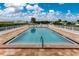 Community pool with clear water and a surrounding deck at 414 Circlewood Dr # H2, Venice, FL 34293