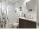 Well-lit bathroom with black-and-white shower curtain, modern fixtures, and tiled backsplash at 425 Nassau S St, Venice, FL 34285