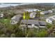 Aerial view of condo unit with green lawn, palm trees, and a pond in the background at 4260 Placida Rd # 11D, Englewood, FL 34224