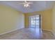 Bedroom with a ceiling fan, tile floors, and sliding glass doors to the backyard at 4966 Sunnyvale Rd, North Port, FL 34288