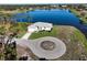 Waterfront home with circular driveway, beautiful landscaping, and serene lake views at 5 Reef Ct, Placida, FL 33946