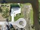 This is an aerial view of the home, with a circular driveway, surrounding canal, and private dock at 5 Reef Ct, Placida, FL 33946