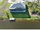 Aerial view featuring a screened-in lanai and private dock in a desirable waterfront setting at 5 Reef Ct, Placida, FL 33946