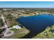 An aerial view of the neighborhood showing the house on a large body of water at 5 Reef Ct, Placida, FL 33946