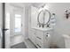 Well-lit bathroom featuring a modern vanity with white cabinets and black hardware at 5 Reef Ct, Placida, FL 33946