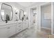 Bathroom featuring double sinks, modern fixtures, and a view into another room at 5 Reef Ct, Placida, FL 33946