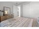Comfortable bedroom with a decorative mirror over a wood dresser, and a large closet at 5 Reef Ct, Placida, FL 33946