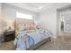 Bright bedroom featuring a patterned rug, a comfortable bed, and a view into an open hallway at 5 Reef Ct, Placida, FL 33946