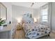 Cozy bedroom featuring a patterned bedspread, dresser, and bedside tables with lamps at 5 Reef Ct, Placida, FL 33946