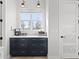 Charming coffee bar area with navy cabinetry, light countertops, stainless appliances, and a window for natural light at 5 Reef Ct, Placida, FL 33946