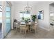 Bright dining area with views of the lake, round table, and modern chandelier lighting at 5 Reef Ct, Placida, FL 33946