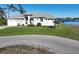 Well-maintained single-story home with a two-car garage, lovely landscaping, and waterfront view at 5 Reef Ct, Placida, FL 33946