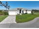 Charming one-story home featuring a brick driveway, attached garage, and a well-kept lawn at 5 Reef Ct, Placida, FL 33946