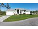 Attractive one-story home with well-manicured lawn and two-car garage, nestled near a tranquil lake at 5 Reef Ct, Placida, FL 33946