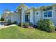 Charming single-story home featuring a beautifully landscaped front yard and a welcoming glass-door entrance at 5 Reef Ct, Placida, FL 33946