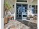 Stylish front entrance with double doors, sleek sconces, modern seating and attractive plantings at 5 Reef Ct, Placida, FL 33946