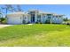 Well maintained front yard with fresh green grass and an inviting covered entryway at 5 Reef Ct, Placida, FL 33946