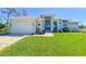 Beautiful single Gathering home with a well manicured lawn and a brick paved driveway and walkway at 5 Reef Ct, Placida, FL 33946