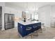 Bright kitchen with stainless steel appliances, a large blue island, and modern pendant lighting at 5 Reef Ct, Placida, FL 33946