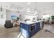 Spacious kitchen with a blue island, stainless steel appliances, and a seamless connection to the living area at 5 Reef Ct, Placida, FL 33946