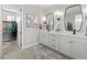 Main bathroom featuring double sinks, modern fixtures, and a walk-in closet at 5 Reef Ct, Placida, FL 33946