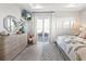Main bedroom with a dresser, television, and a view of the lake at 5 Reef Ct, Placida, FL 33946