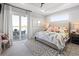 Stylish main bedroom with patio access and a view of the lake beyond at 5 Reef Ct, Placida, FL 33946