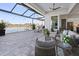 Spacious screened patio featuring comfortable lounge seating and views of the lake at 5 Reef Ct, Placida, FL 33946
