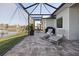 Covered patio area with outdoor seating, lake views, and a grilling area at 5 Reef Ct, Placida, FL 33946