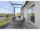 Covered patio with dining area and lake views, perfect for outdoor entertaining at 5 Reef Ct, Placida, FL 33946