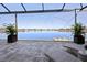 Covered patio featuring serene lake views, lounge chairs, and tiled flooring at 5 Reef Ct, Placida, FL 33946