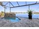 Sparkling pool with spa showcasing a rock waterfall and an expansive lake view at 5 Reef Ct, Placida, FL 33946