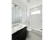 Modern bathroom features a sleek vanity, white tile backsplash, tub, and contemporary fixtures at 5213 Willow Lake Ct, Sarasota, FL 34233