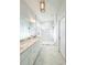 Bright bathroom features double vanity with marble countertops, a frameless glass shower, and marble floors at 5213 Willow Lake Ct, Sarasota, FL 34233