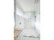 Bright bathroom features a glass shower, marble floors, and a single vanity with marble countertop at 5213 Willow Lake Ct, Sarasota, FL 34233
