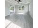 Spacious room with tray ceilings, a ceiling fan, sliding doors, and wide plank tile floors at 5213 Willow Lake Ct, Sarasota, FL 34233