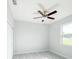 This is a spacious bedroom with light wood floors, a ceiling fan, and a window at 5213 Willow Lake Ct, Sarasota, FL 34233