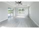Spacious room with tray ceilings, ceiling fan, a large window, and sliding doors that lead to an outdoor pool at 5213 Willow Lake Ct, Sarasota, FL 34233