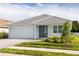 Beautiful single-story home with a well-maintained lawn, gray tile roof, and a brick paver driveway at 5213 Willow Lake Ct, Sarasota, FL 34233