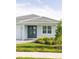 Close-up of a home's exterior, showcasing double doors, a window, and lush landscaping at 5213 Willow Lake Ct, Sarasota, FL 34233