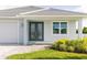 The house features a front entrance with attractive double doors and neat, well-maintained landscaping at 5213 Willow Lake Ct, Sarasota, FL 34233