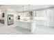 Modern kitchen featuring a large island, white cabinetry, stainless steel appliances, and sleek countertops at 5213 Willow Lake Ct, Sarasota, FL 34233