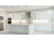 Bright kitchen features white cabinets, marble countertops, an island, and stainless steel appliances at 5213 Willow Lake Ct, Sarasota, FL 34233
