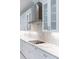 Close up view of a kitchen featuring white cabinets, marble countertops and backsplash, and stainless steel appliances at 5213 Willow Lake Ct, Sarasota, FL 34233