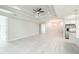 Bright, open-concept living space with wood-look tile, recessed lighting, ceiling fan, and chandelier at 5213 Willow Lake Ct, Sarasota, FL 34233