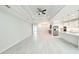 Spacious, open-concept living space with wood-look tile, recessed lighting, kitchen, and ceiling fan at 5213 Willow Lake Ct, Sarasota, FL 34233
