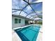 Private screened in pool features sparkling blue water with an attached spa at 5213 Willow Lake Ct, Sarasota, FL 34233