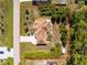Aerial view of a single-Gathering home featuring a screened lanai, mature landscaping, and a long driveway at 5441 Farley St, Port Charlotte, FL 33981