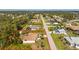 Aerial view outlining the home's property, neighborhood, and proximity to a nearby lake at 5441 Farley St, Port Charlotte, FL 33981