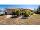 Side yard showcasing a patio area, tropical landscaping, and screened-in lanai at 5441 Farley St, Port Charlotte, FL 33981